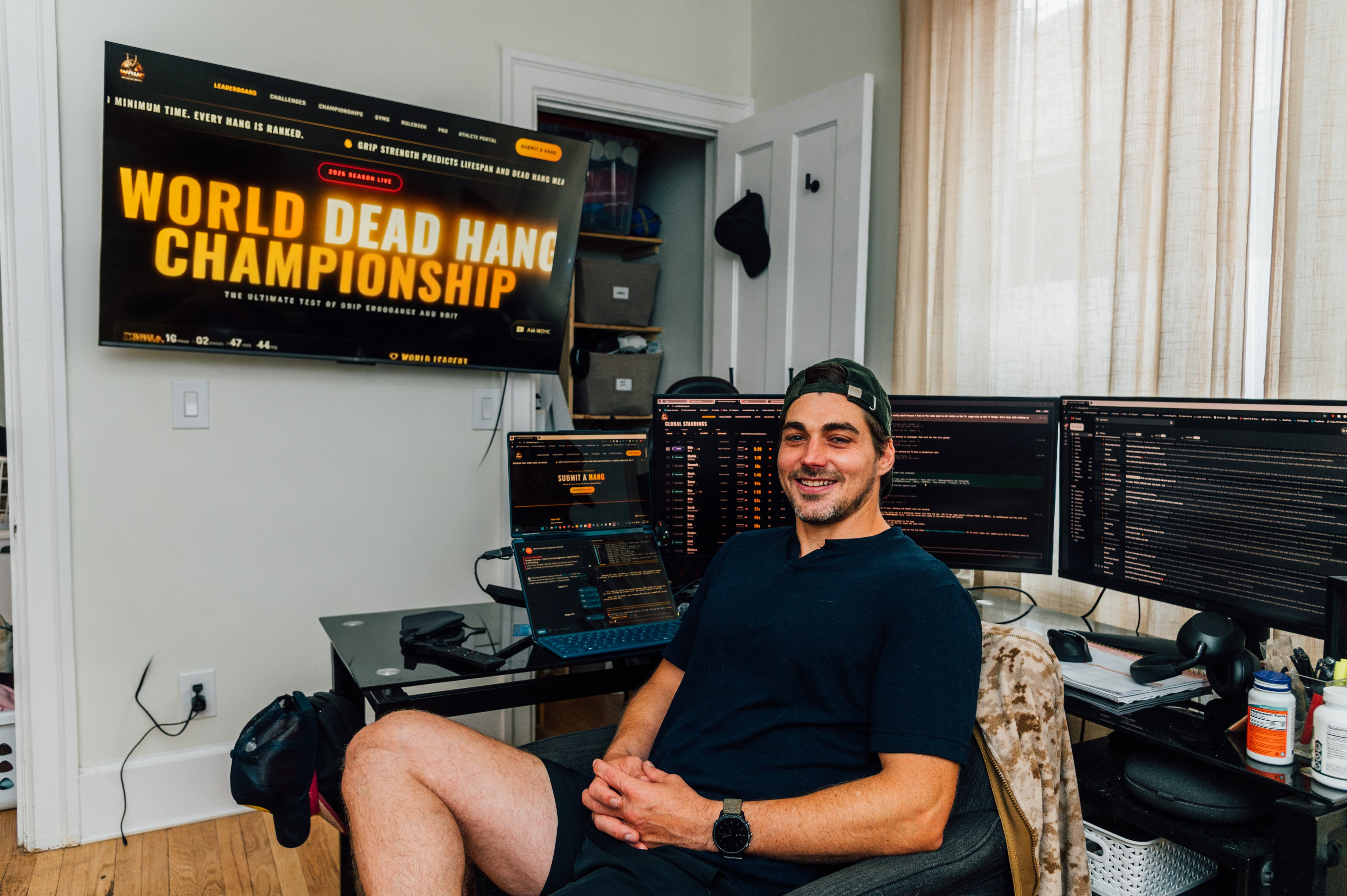 Milo Birk at World Dead Hang Championship headquarters with the live site on the wall display